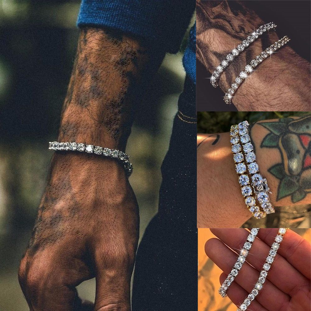 A hand adorned with multiple sparkling diamond bracelets, showcasing intricate designs and tattoos.